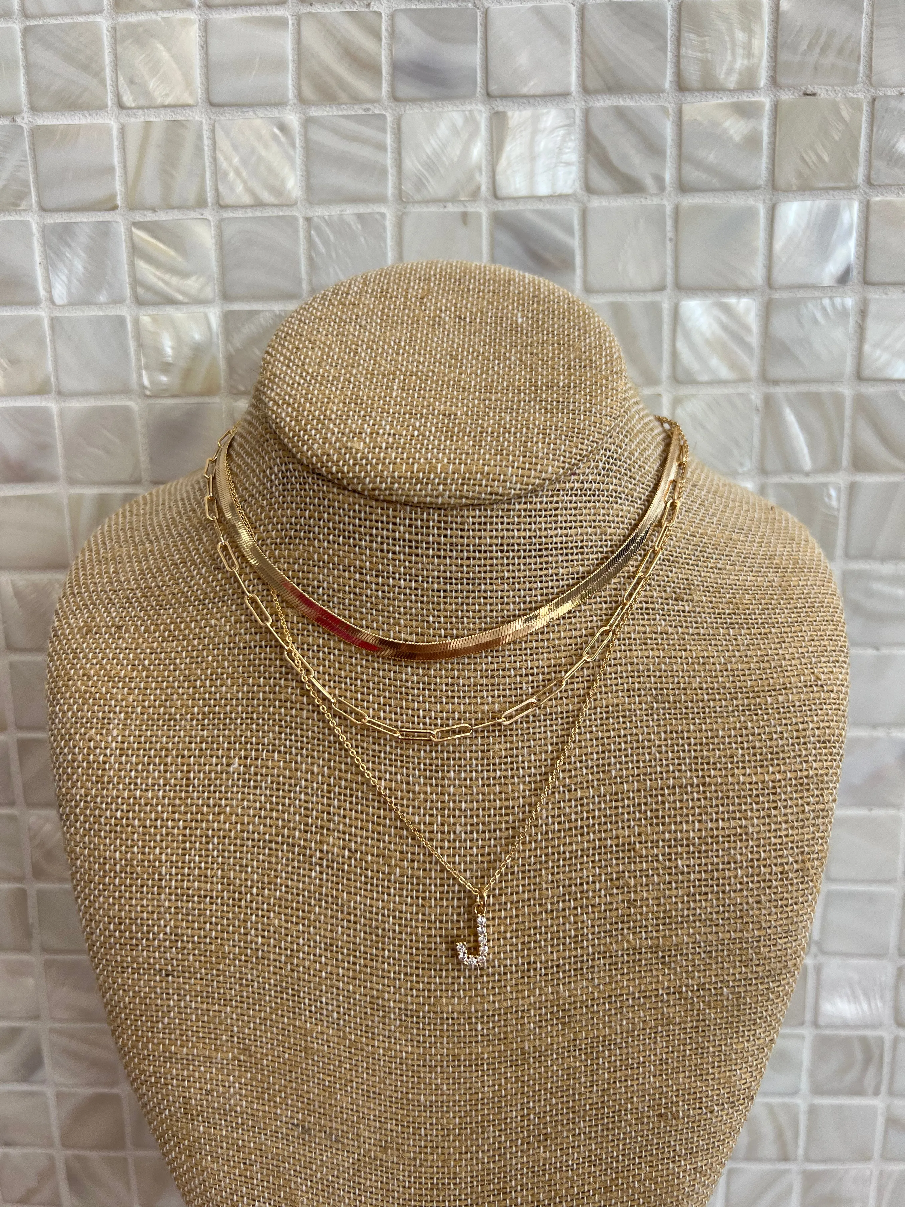 GOLD SNAKE, PAPERCLIP, AND CRYSTAL PENDANT INITIAL LAYERED NECKLACE