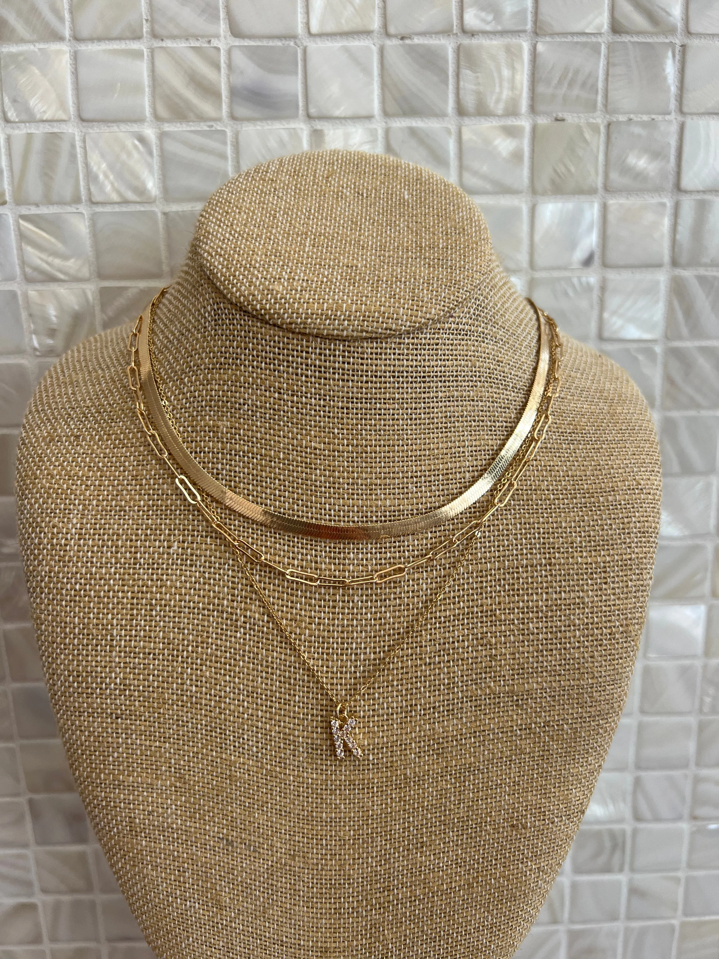 GOLD SNAKE, PAPERCLIP, AND CRYSTAL PENDANT INITIAL LAYERED NECKLACE