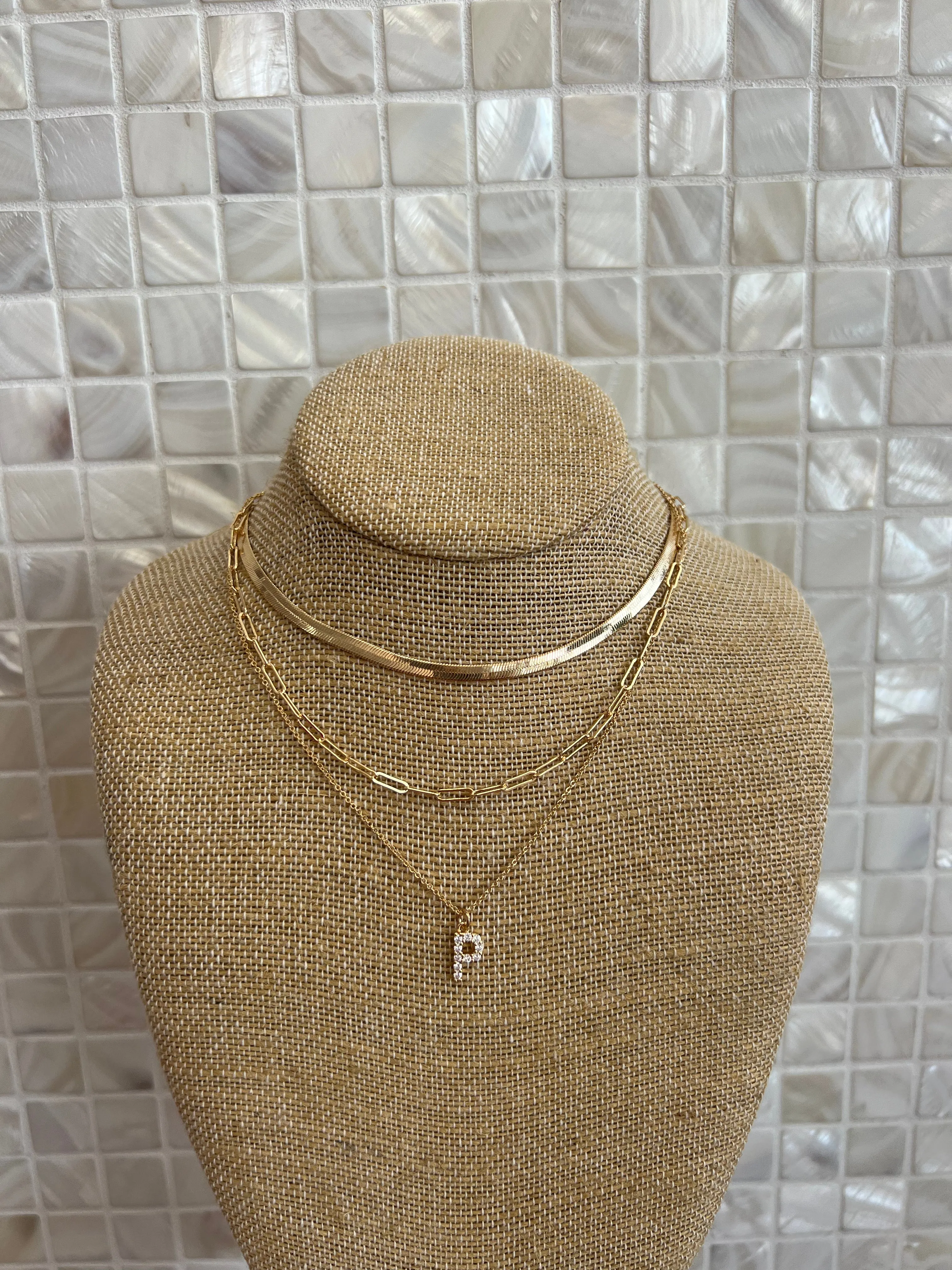 GOLD SNAKE, PAPERCLIP, AND CRYSTAL PENDANT INITIAL LAYERED NECKLACE