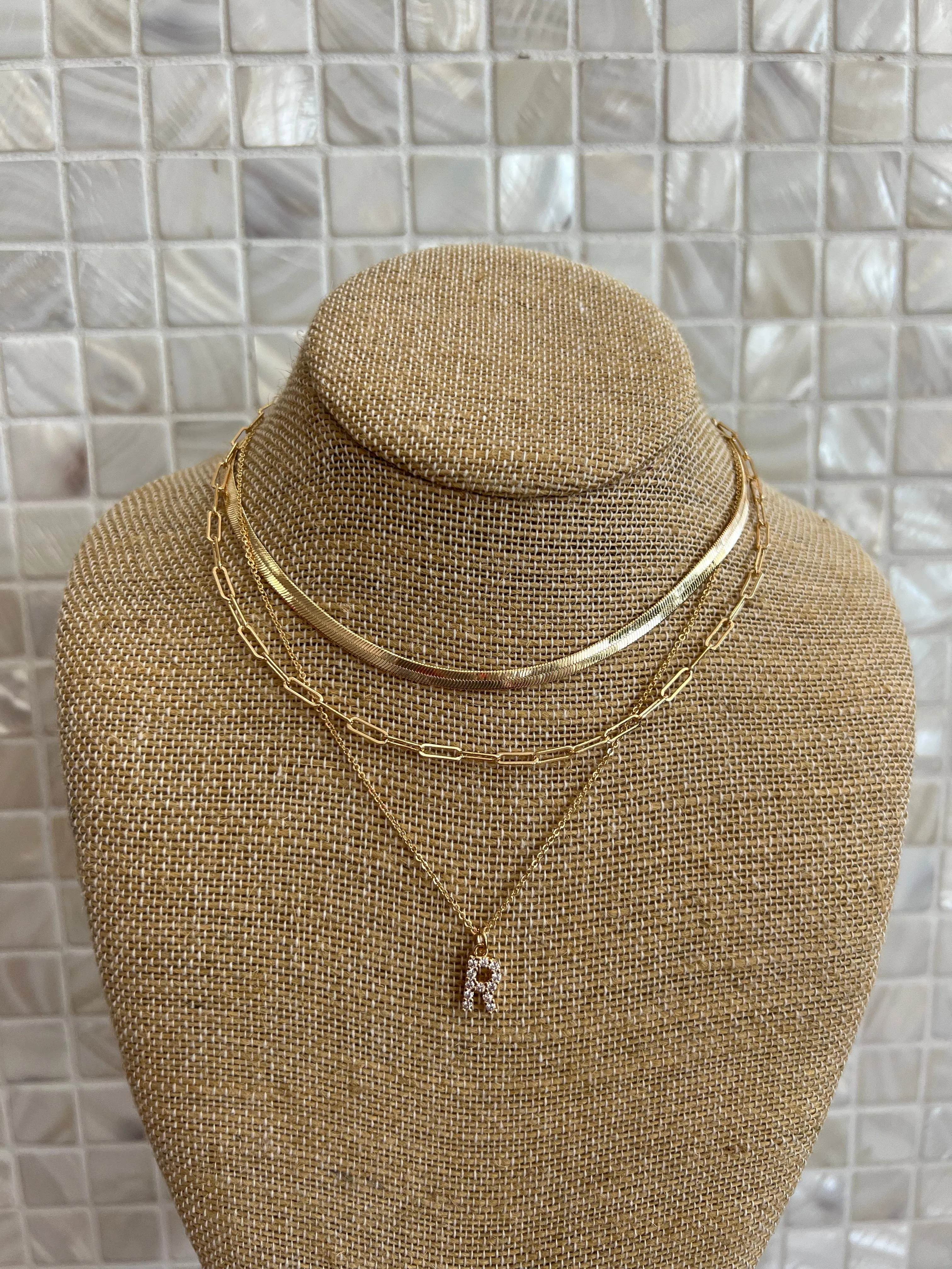 GOLD SNAKE, PAPERCLIP, AND CRYSTAL PENDANT INITIAL LAYERED NECKLACE